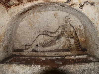 The tomb&rsquo;s centerpiece carving depicts a reclining man.