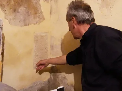 Artist Jean Charles Blais and his contractor discovered the engraving behind a layer of plaster on his studio wall.