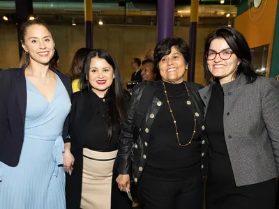 Four women pose for a group photo.