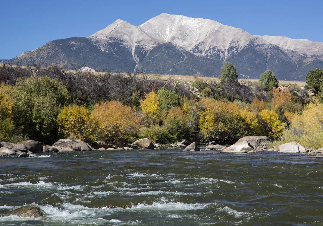 Snow-capped mountain behind river