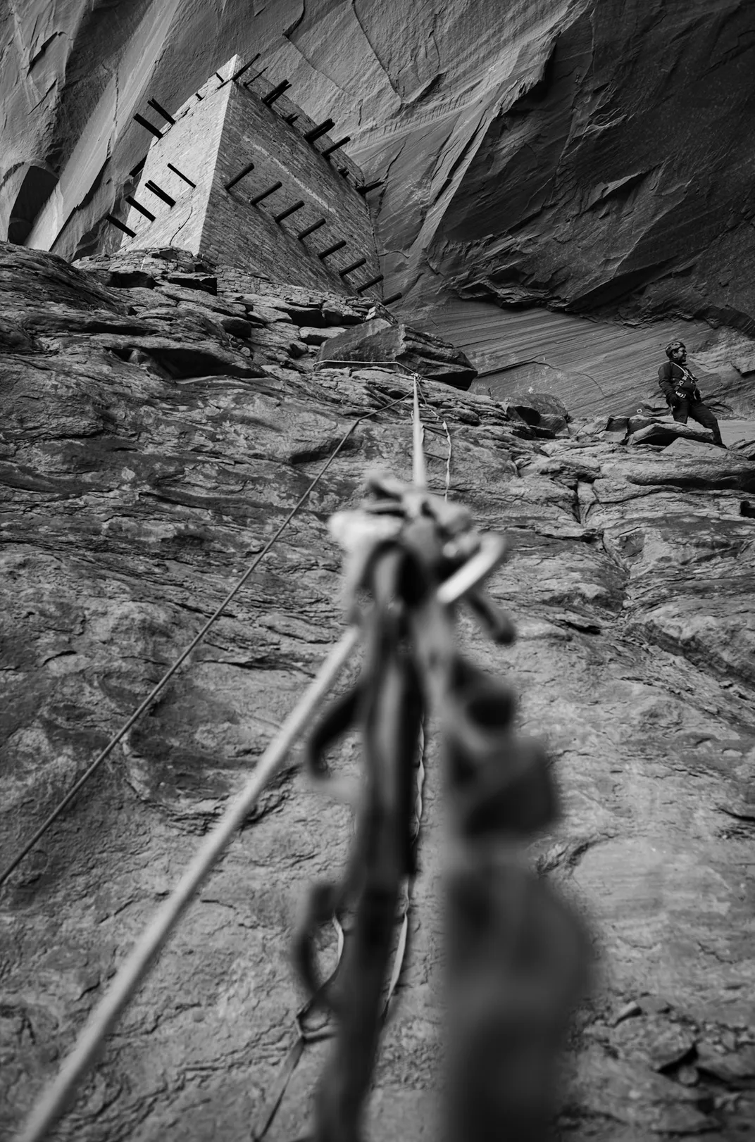 The view as our photographer ascends the anchored ropes and portable ladders that allow team members in climbing harnesses to haul gear and equipment. NPS archaeologist Josh Ramsey looks on from above.