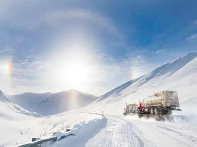 With a sunny &ldquo;halo&rdquo; to point the way, a truck climbs into the Brooks Range towards Atigun Pass, heading for Fairbanks after departing the oilfields of Prudhoe Bay.

