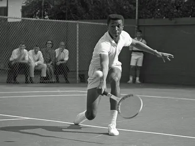 Arthur Ashe&nbsp;playing tennis against Dennis Ralston in 1964