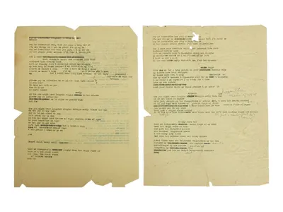 The two sheets of yellowed paper contain three typewritten drafts of the iconic song.