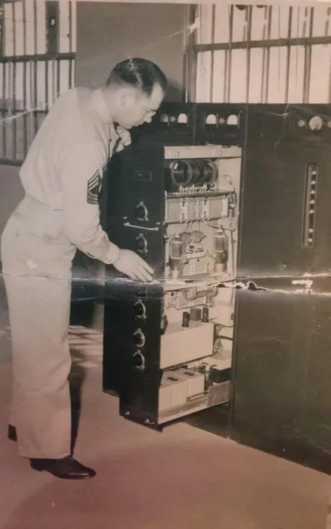 Robert Espe stands by a ham radio in a room in his house dedicated to his lost wife and son.
