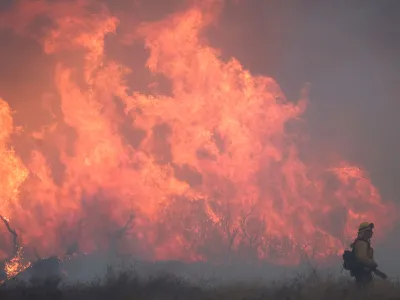 A firefighter works as the Hughes Fire burns north of Los Angeles on January 22.