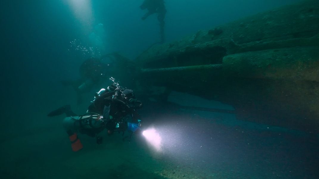 Diver Nathan Martel inspects the stern of the wreck of UC-18.