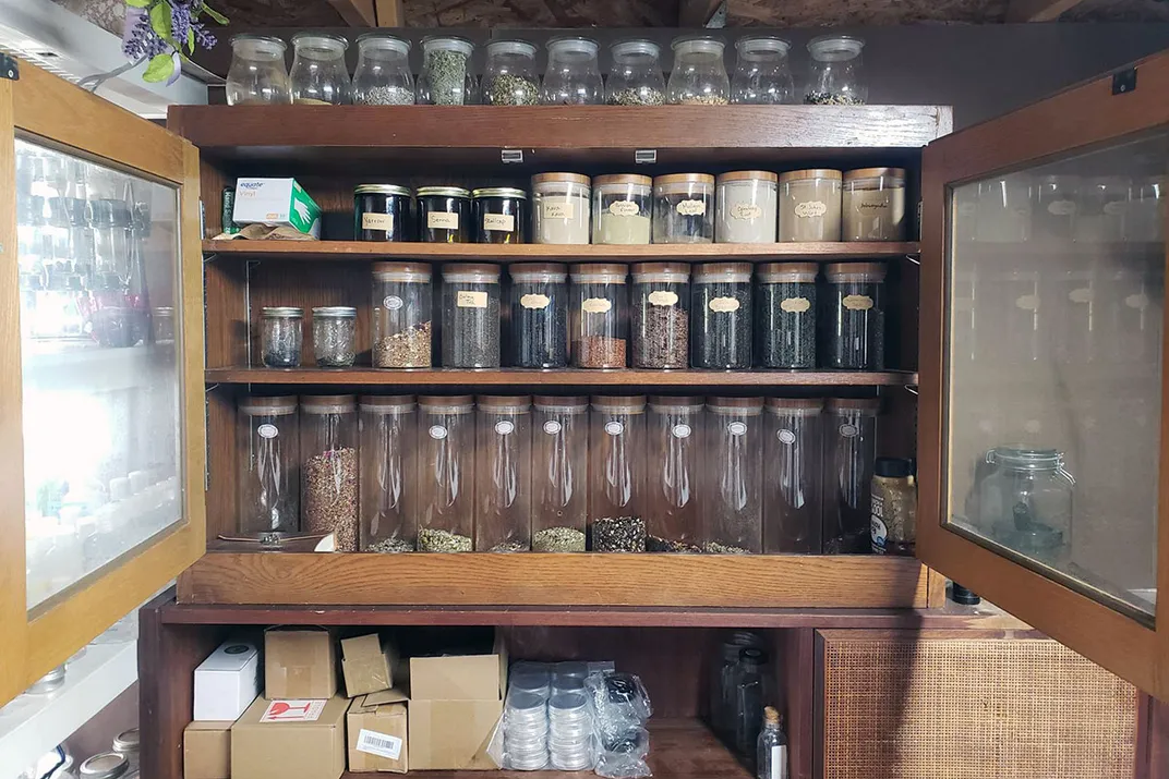 A cabinet full of glass jars.