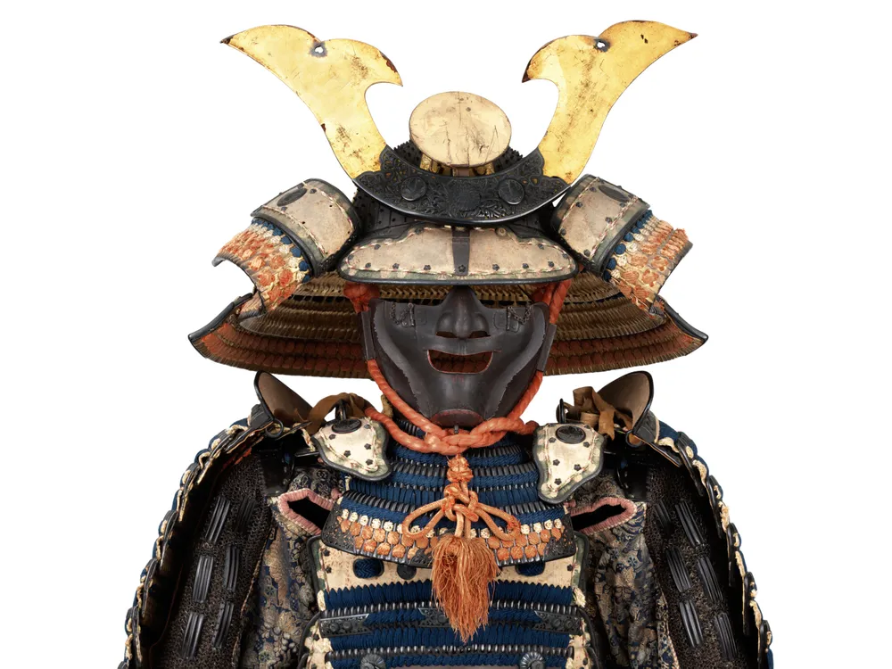 OPENER DETAIL - This suit of armor bears the crest of the powerful Ikeda family. The helmet dates to the 14th century, and the suit—including the bear-fur shoes—dates to the 18th.