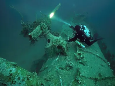 Diver Chris de Putron inspects the wreck of the German submarine UC-18, which sank off the Channel Islands in February 1917.