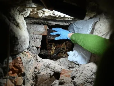 Researchers found the pieces covered in newspaper and tucked beneath a staircase in the crypt.